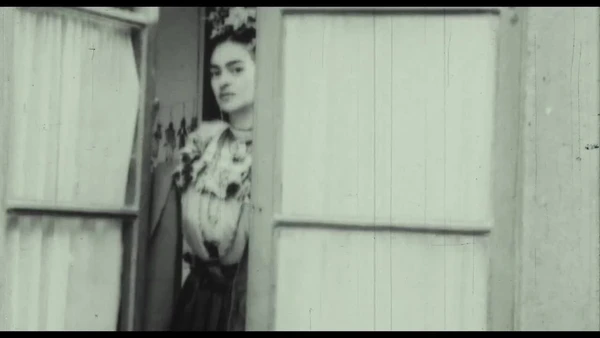 Frida peeks through a door in "Frida: Viva la Vida".
