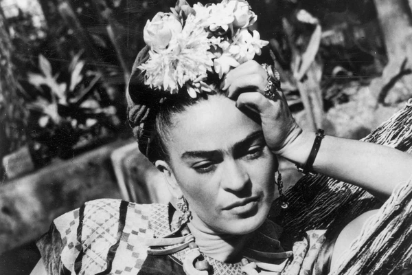 Frida relaxes with flowers in hair in "Frida: Viva la Vida".