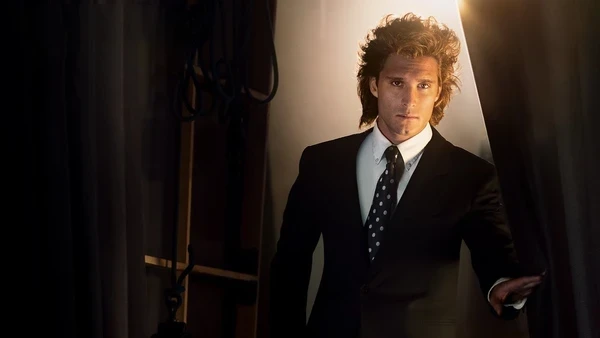 Luis Miguel enters from backstage in "Luis Miguel: The Series".
